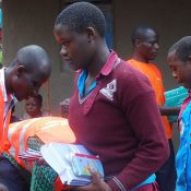 Sume Junior School is one of the schools located in Bukalasi Sub County at the banks of river Sume. The school was greatly affected with massive damage leaving one pupil dead and some of the school structures damaged. The school was left destroyed with no hopes for the future The pupils and staff expressed that their future hopes were no more wondering on how to cope up with their studies because their notes were washed away and they could not think of how to recover them. This accelerated the rate of absenteeism and dodging of classes, to make matters worse it was so hard for the girls to manage their monthly flows because of lack of sanitary kits. They used pieces of clothes during that time of the month which at times fell in public. This led to shame and bringing about inferiority complex amongest most of them. The girls and staff further expressed that most of the aid in disaster hit areas neglects the rights of children in terms of scholastic materials and sanitary materials. However with the love of sharing with the needy communities, they are extremely happy for the support extended to them inform of scholastic materials and sanitary kits by PAG. This has boomed school attendance because the pupils have all they need to attend school. The soap enables them to be smart as they wash up their clothes and manage personal hygiene, the pads and knickers give them comfort whenever they are in their periods and they can associate freely with other pupils. The pupils and staff thanked P.A.G for the great love and requested for more support to those from disadvantaged households and those who did not access such service to enable them achieve.